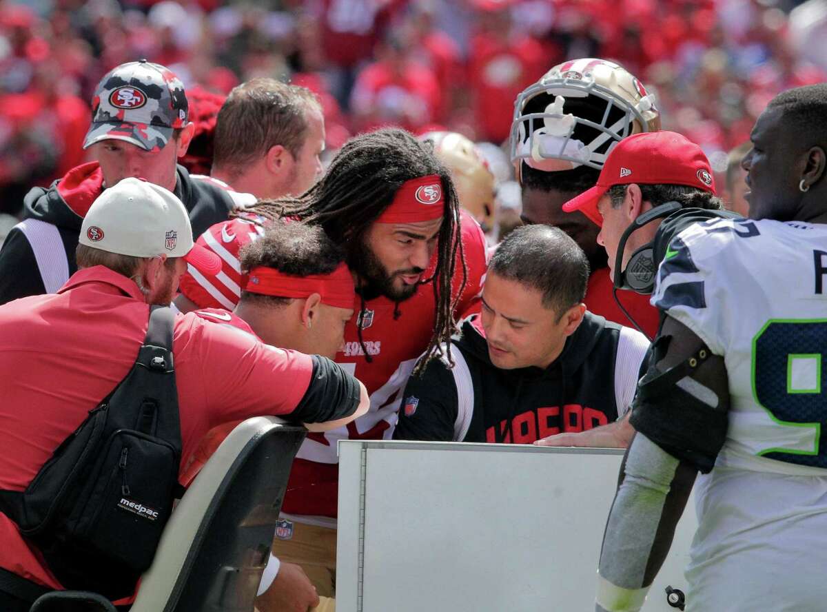 Fred Warner (54) hugs Trey Lance (5) as he is placed on a cart after suffering a lower leg injury in the first half as the San Francisco 49ers played the Seattle Seahawks at Levi’s Stadium in Santa Clara, Calif., on Sunday, September 18, 2022.