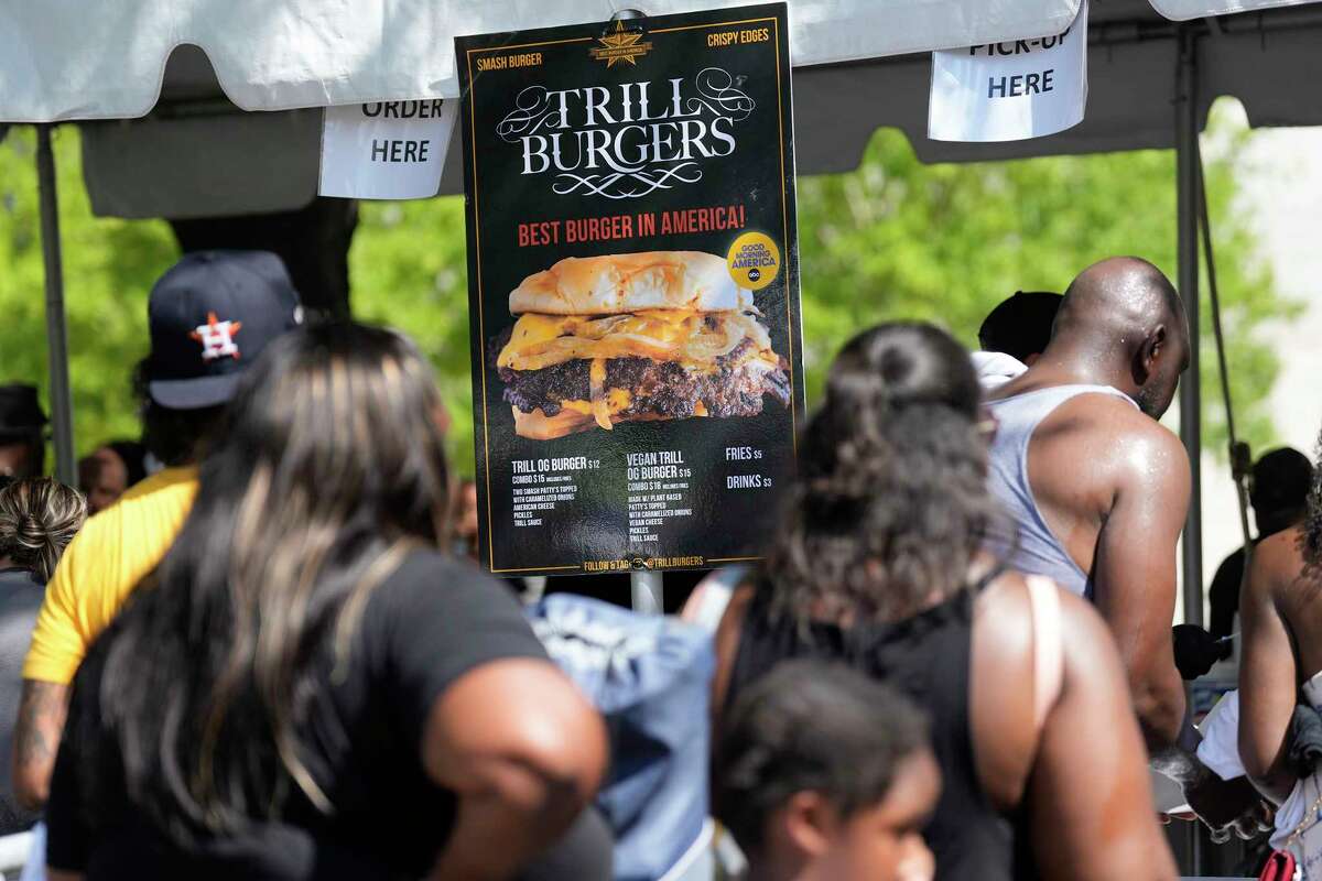 People make a line to be able to buy a Bun B’s Trill Burgers at the Houston City Hall, Sunday, Sept. 18, 2022, in Houston.