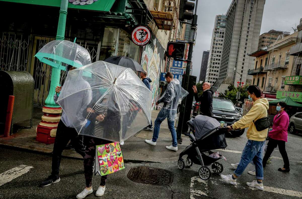 Umbrellas come in handy during rainfall on San Francisco’s Chinatown. The storm brought surprise and relief during a season typically marked by grueling wildfires and protracted drought.