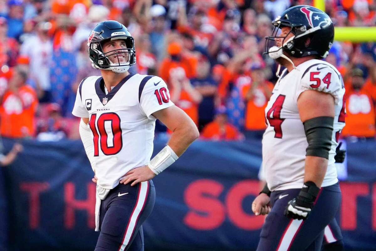 Houston Texans quarterback Davis Mills (10) walks off the field after giving up the ball on downs to the Denver Broncos during the fourth quarter of an NFL football game Sunday, Sept. 18, 2022, in Denver. The Broncos won 16-9.