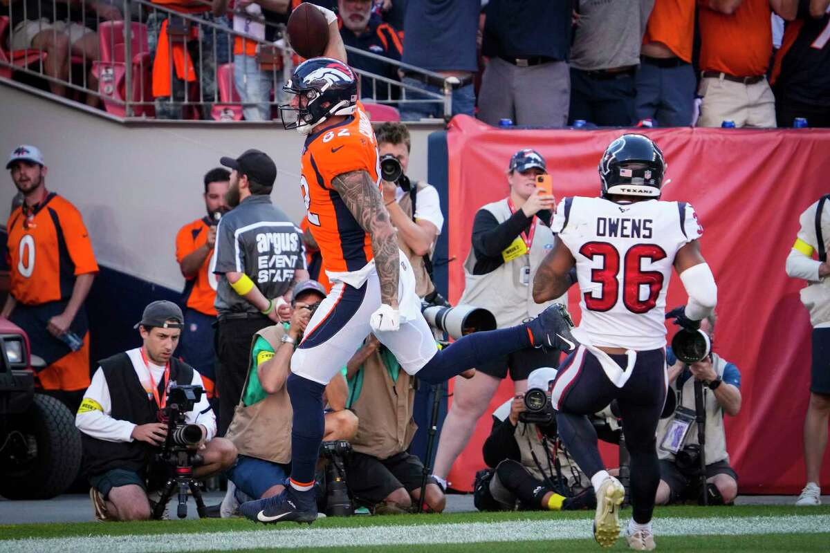 Denver Broncos tight end Eric Saubert (82) celebrates his 22-yard touchdown reception as he runs past Houston Texans safety Jonathan Owens (36) in the end zone during the fourth quarter of an NFL football game Sunday, Sept. 18, 2022, in Denver.