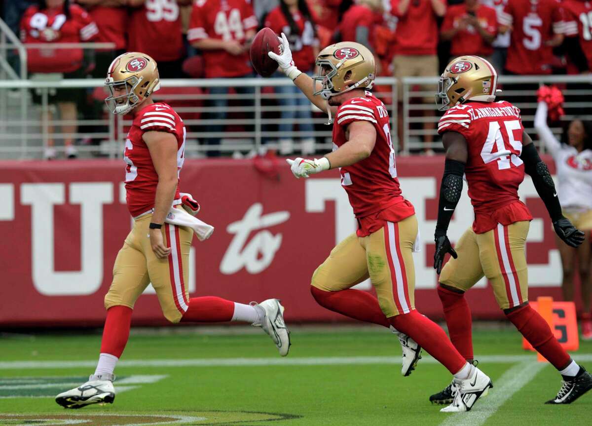 Niners tight end Ross Dwelley (center) celebrates after recovering a muffed punt in the first half at Levi’s Stadium. Dwelley also had a 38-yard TD catch in the win over the Seahawks.