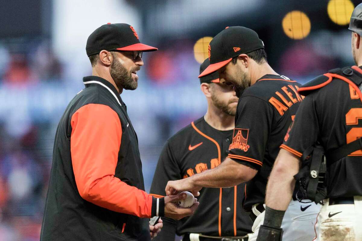 San Francisco Giants relief pitcher Scott Alexander, right, is removed from the game by manager Gabe Kapler, left during the seventh inning of a baseball game in San Francisco, Sunday Sept. 18, 2022. (AP Photo/John Hefti)