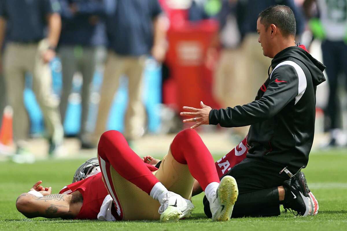 San Francisco 49ers’ Trey Lance lays on the turf after injuring his ankle in 1st quarter against Seattle Seahawks during NFL game at Levi’s Stadium in Santa Clara, Calif., on Sunday, September 18, 2022.