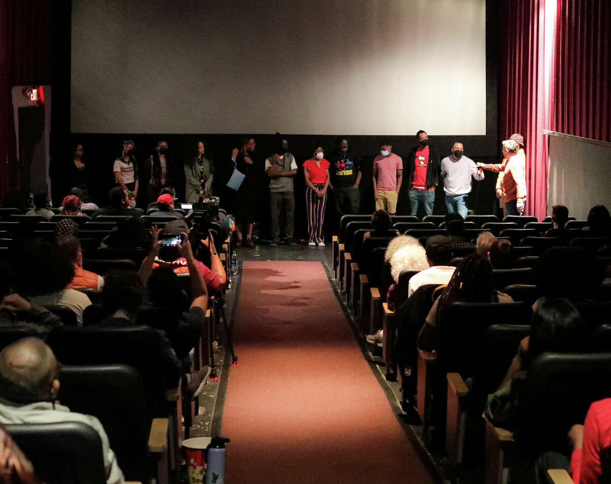 The Youth FX Arts2Work fellows take a bow in front of a movie screen at Landmark Spectrum Theater in Albany, N.Y. on May 24, 2022. The fellows screened their first major Arts2Work project, short portrait documentaries, at the theater. (Courtesy of Youth FX)
