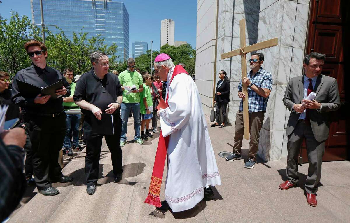 Archbishop Emeritus Joseph A. Fiorenza welcomes the faithful to the Co-Cathedral of the Sacred Heart during a Way of The Cross procession Friday, April 19, 2019, in Houston. Priests and hundreds of lay people attend the pilgrimage through Houston's Montrose, Midtown and Downtown neighborhoods. 