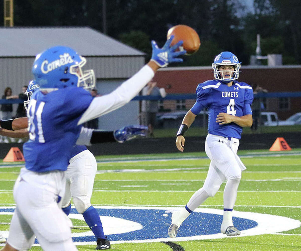 Greenville QB Ryan Jackson (right) watches his pass go off the fingertips of receiver Dieken Graber in the first quarter Friday night at Don Stout Field in Greenville.