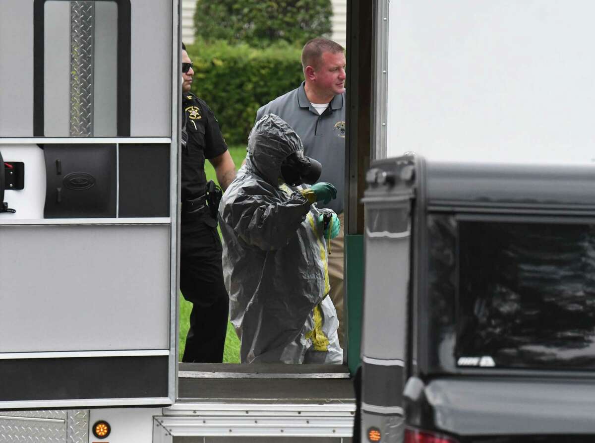 A official in protective is clothing is helped out of their gear after entering an apartment at Netherlands Village where a meth lab was discovered in one of the units at the Dorwaldt Boulevard complex on Monday, Sept. 19, 2022, Schenectady, N.Y.