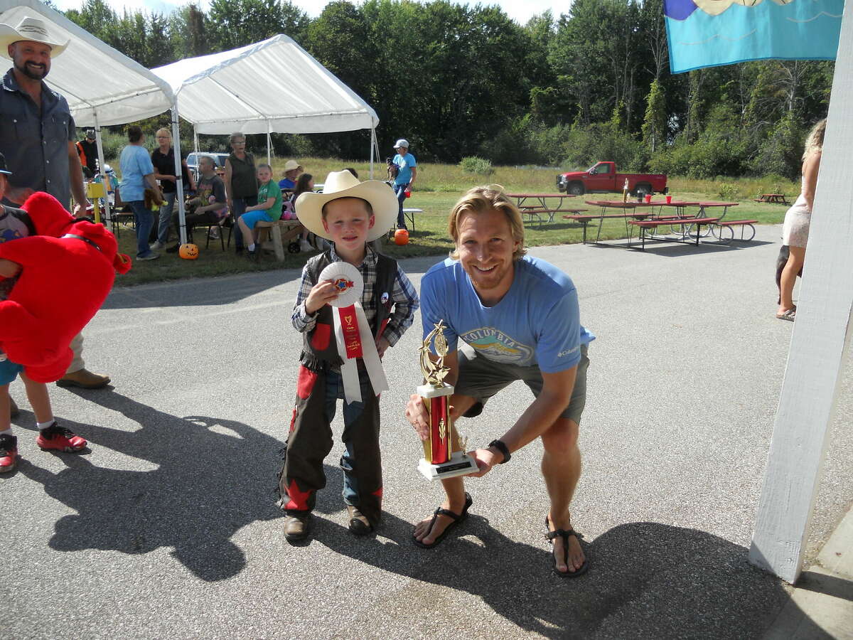 (From center left) Waylan Briggs, of Free Soil, won second place and Alec Omell, of Manistee, took first place in the Blessing of the Animals pie eating contest on Sunday.