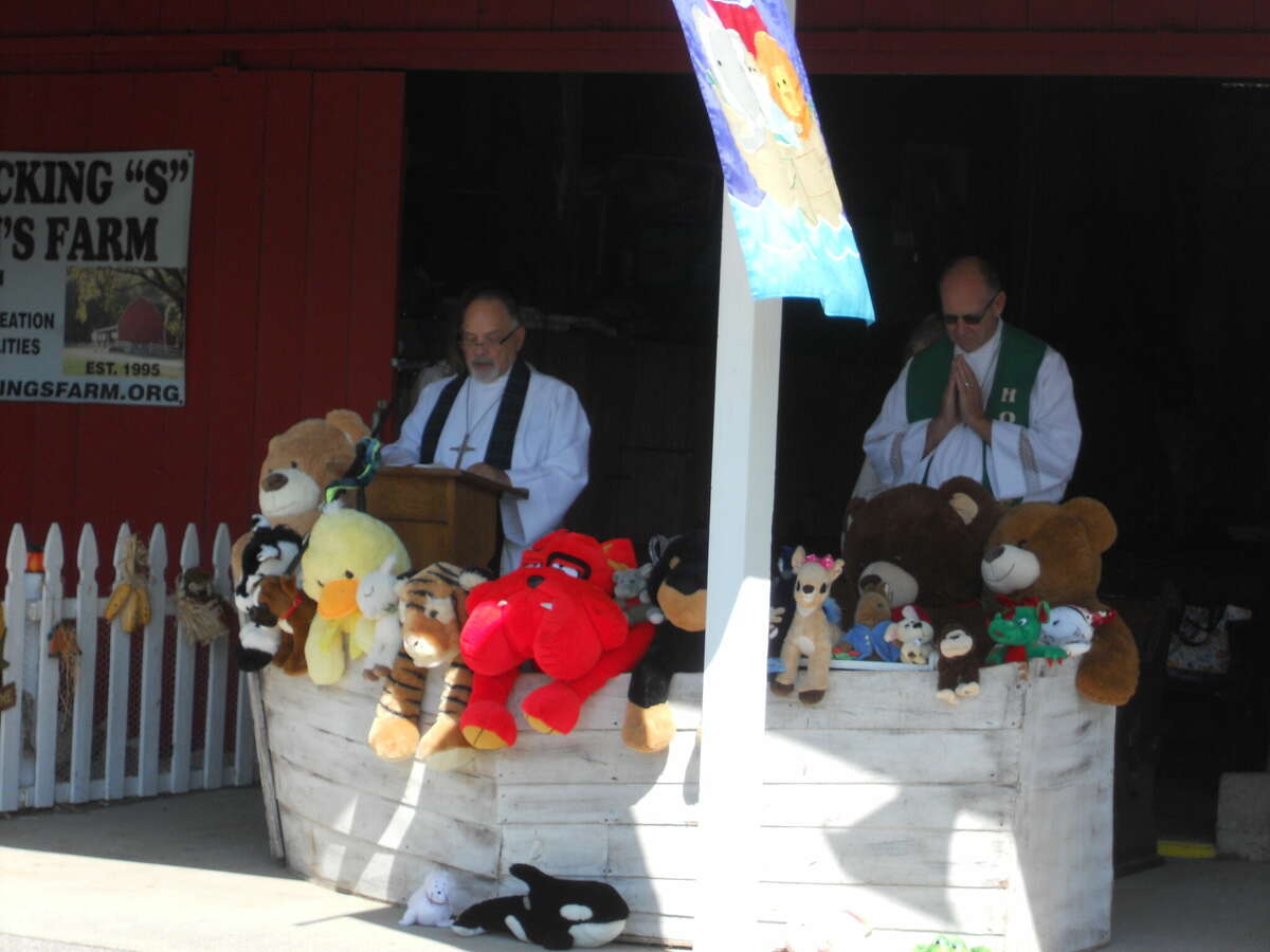 Rev. John Brown and Rev. John Hansen presided over the service blessing dogs, cats, chickens, rabbits, turkeys and stuffed animals on Sunday.
