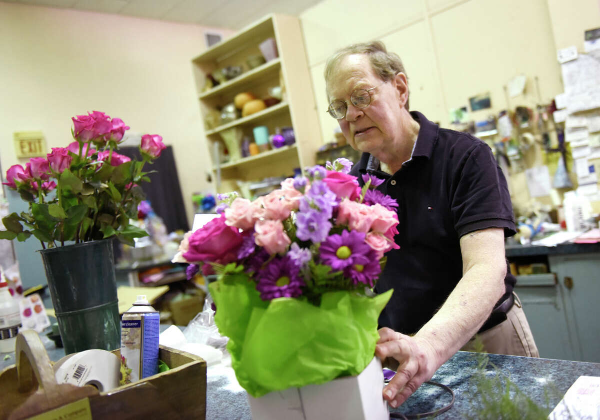 Business owner Peter Rogers assembles a bouquet at Peter Rogers Florist in Stamford, Conn. Monday, Sept. 19, 2022. After nearly 50 years in business and two location changes within Stamford, Peter Rogers Florist will permanently close later this month.