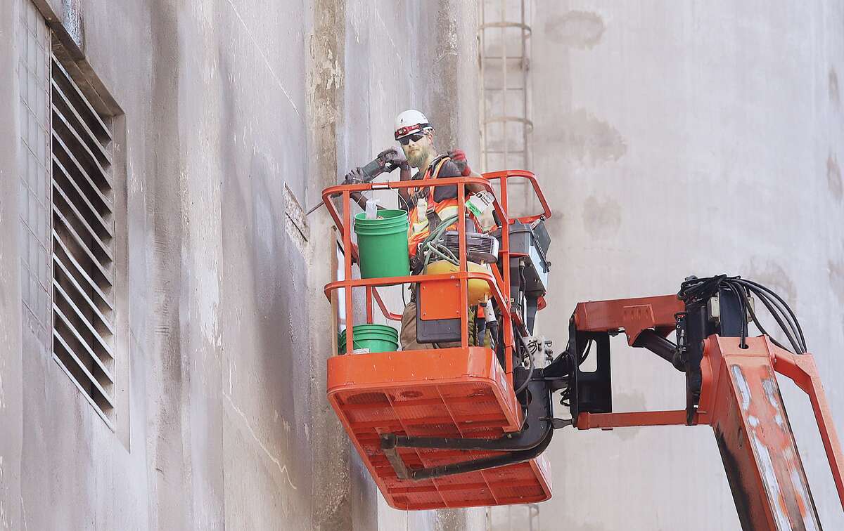 John Badman|The Telegraph More work was underway to remove bad sections of concrete and patch them on the multi-story silos and buildings of Ardent Mills on West Broadway in Alton Monday. The company began making many improvements to the mill complex following the second worst flood in recorded history in 2019. Some of those improvements are ongoing.