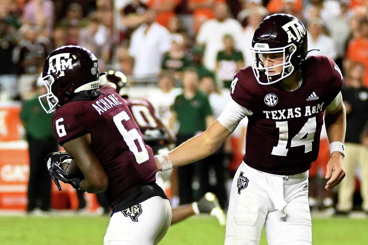 Quarterback Max Johnson, right, and Texas A&M pulled out a much needed win over then-No. 13 Miami on Saturday.