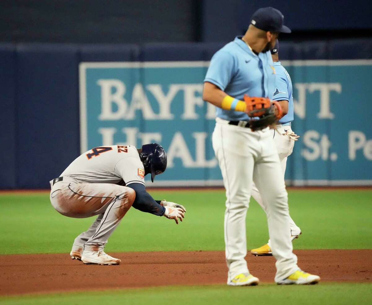 Houston Astros Yordan Alvarez (44) struggles to get up after sliding into second base on his single during the sixth inning of an MLB baseball game at Tropicana Field on Monday, Sept. 19, 2022 in St. Petersburg.
