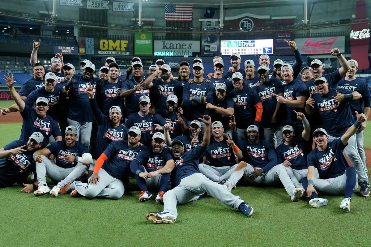 The Houston Astros pose for a photo after clinching the American League West title with a win over the Tampa Bay Rays during a baseball game Monday, Sept. 19, 2022, in St. Petersburg, Fla.