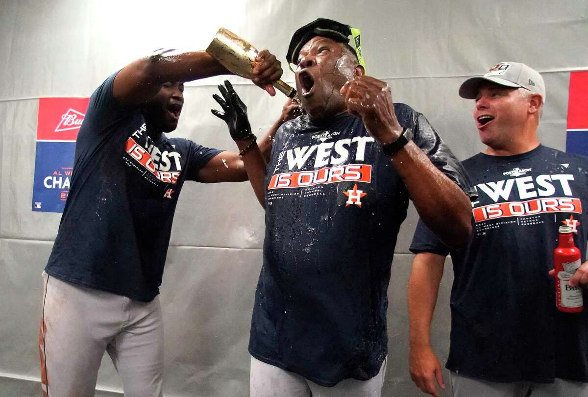 Houston Astros Yordan Alvarez pours champagne on manager Dusty Baker Jr. after they clinched the AL West after beating the Tampa Bay Rays of an MLB baseball game at Tropicana Field on Monday, Sept. 19, 2022 in St. Petersburg.