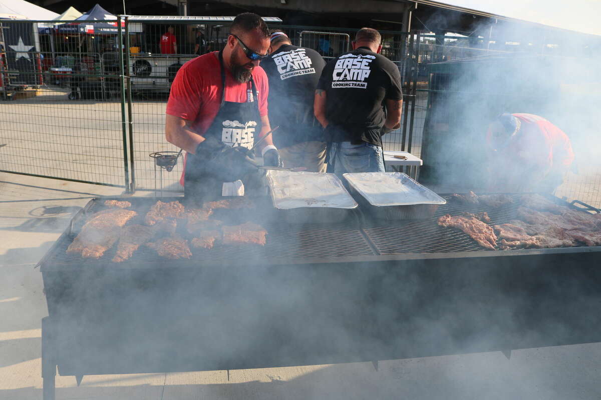 The Base Camp Cooking Team grills something very meaty behind the Gilley's tent during Cook's Choice Night at the cookoff.