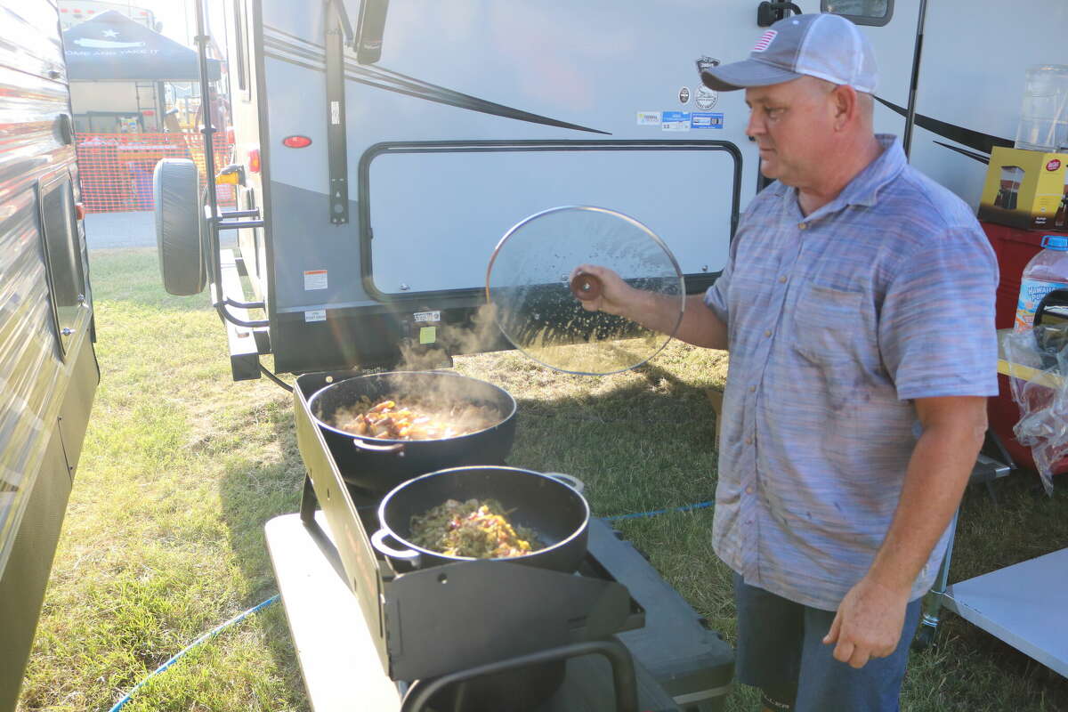 Newly Landrum pulls the lid off a meal he's preparing during the recent Pasadena Livestock Show & Rodeo Cookoff. 