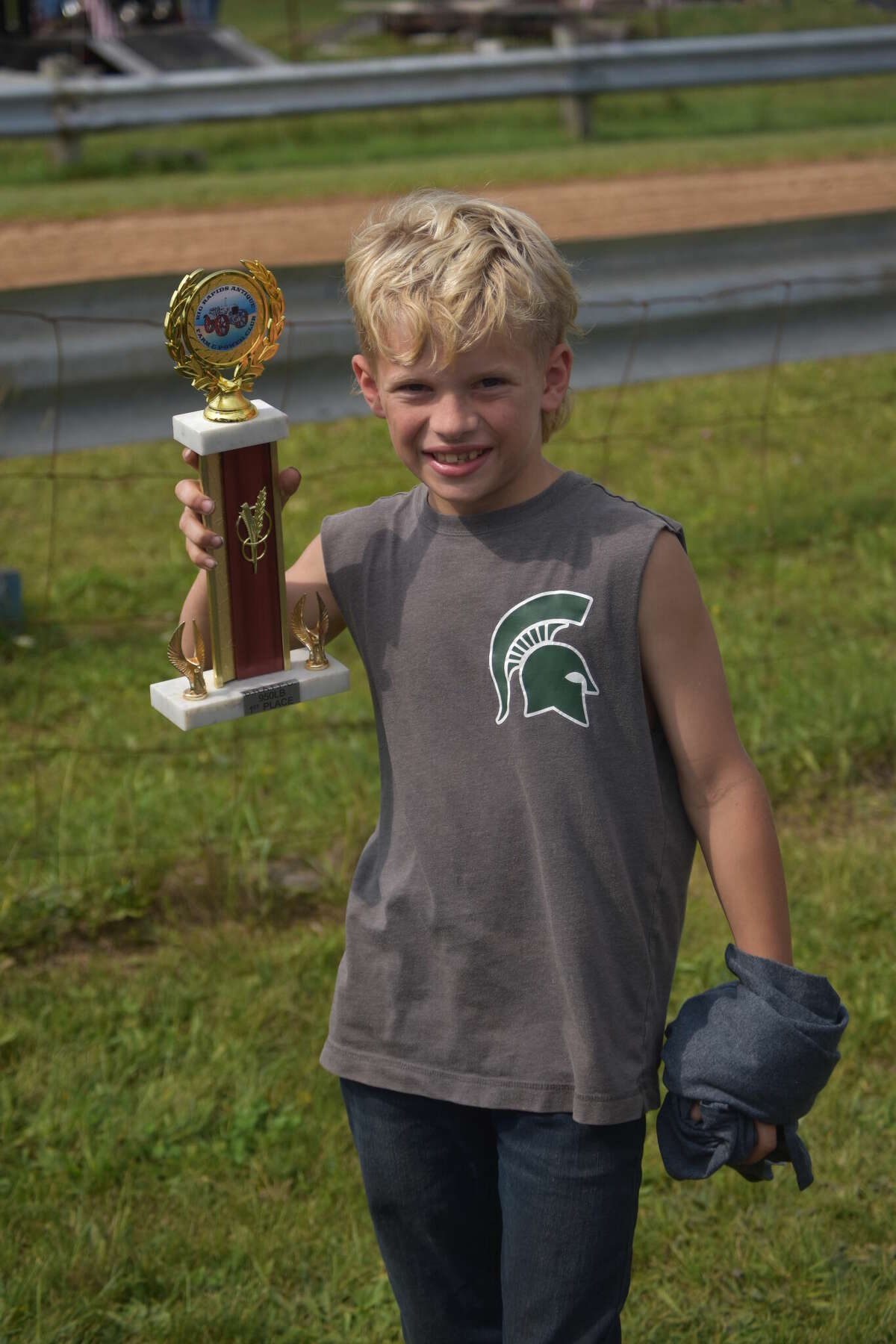 Twenty-six tractors competed in Saturday's tractor pull, wrapping up the season for the Big Rapids Antique Farm and Power Club. Above, 10-year-old Nate, won the 850 and 950 pound twin categories.