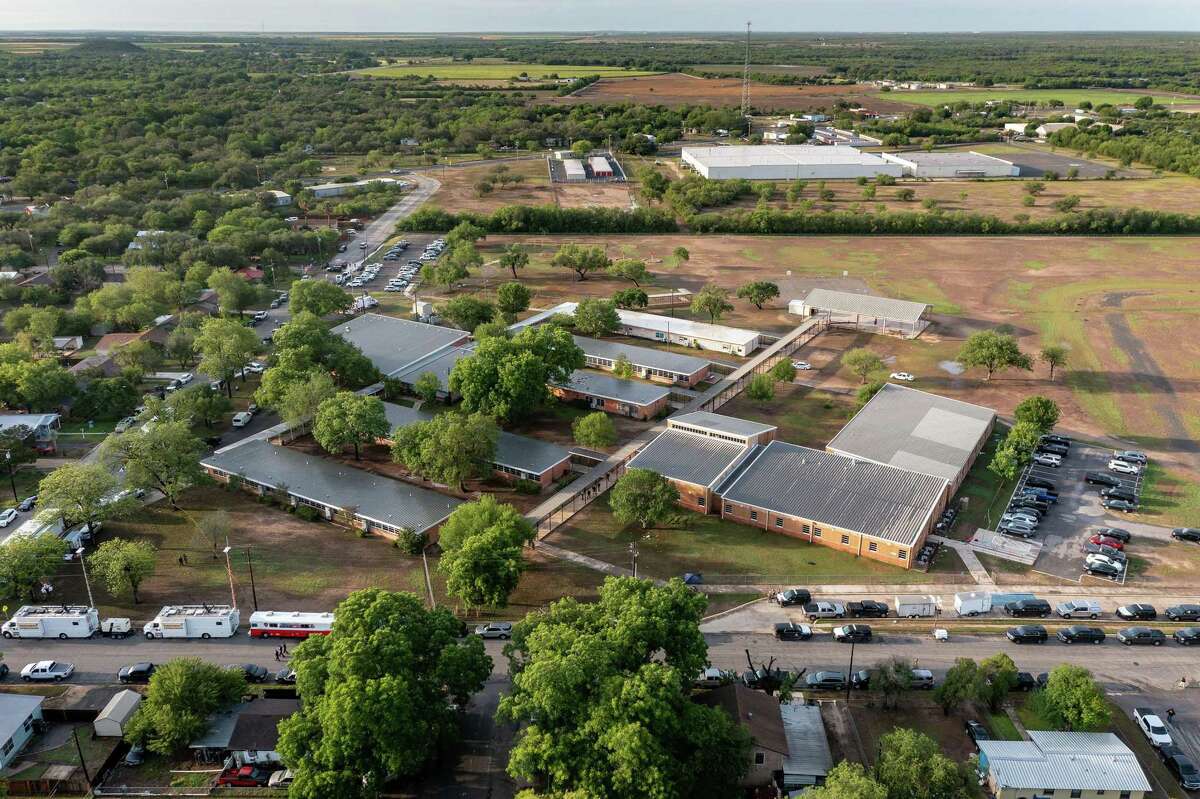 In this aerial view, law enforcement officers work at Robb Elementary School on May 25 in Uvalde, the day after a gunman killed two teachers and 19 children there. (Jordan Vonderhaar/Getty Images/TNS)