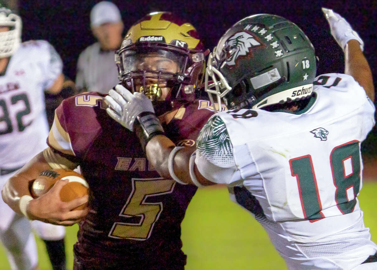 EA-WR quarterback Miguel Romero (5) runs into Salem's Jervace Mayes (18) Friday night. Mayes was called for a facemask penalty, in the Oilers' win at Memorial Stadium.