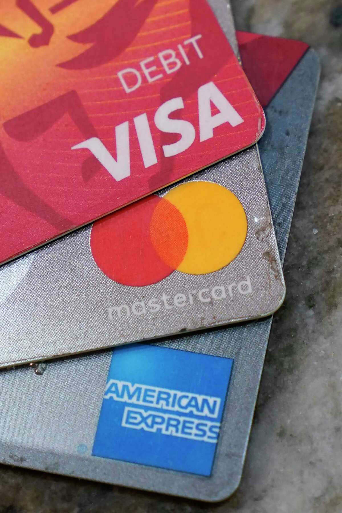 FILE - American Express, Visa and Master card cards are on display in Richmond, Va., Thursday, July 1, 2021. A group of Republican attorneys general are pushing the major payment networks _ Visa, Mastercard and American Express _ to drop their plans to start tracking sales at gun stores, arguing the plans could infringe on consumer privacy and push legal gun sales out of the mainstream financial network. The letter comes more than a week after the payment networks said they would adopt the International Organization for Standardization’s new merchant code for sales at gun stores.