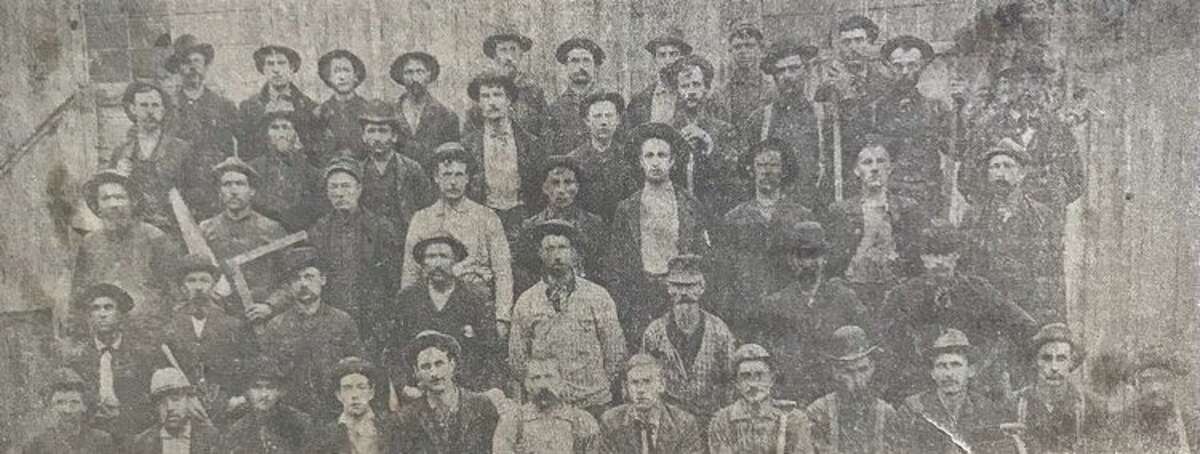 This is a photograph of workers of the Larkin & Patrick Saw & Shingle Mill and Salt Block at the end of Ann and McDonald streets. It is believed this was taken just after the May 1892 explosion of a boiler that destroyed most of the operation, which was located along the Tittabawassee River known as the river flats. A big thank you to Midland historian and archivist Tawny Ryan Nelb who provided more information on this Daily News photograph of workers of the Larkin & Patrick Saw & Shingle Mill and Salt Block at the end of Ann and McDonald streets. A May 1892 explosion of a boiler destroyed most of the operation, which was located along the Tittabawassee River known as the river flats. Three men died (Richard Steers is not in photograph and 13 men were injured. Nelb provided identifications: Second row, from left, first man is Freddie Highgate, who was subbing for Andrew "Dick" Elbe, who was not at work that day; third is Perry Elton, who was injured.Fourth row, from left, fourth man is Charles Allen, who died in explosion.Fifth row, from left, fifth man is Andrew "Dick" Elbe, who wasn't at work that day; seventh man is Eugene Van Valkenburg, who died in explosion, and 10th man is Albert Moll, who was injured in explosion. Nelb said Elbe, who was at home that day with his wife who was in labor, was very tall and  would have died that day since shrapnel went right over the short-of-stature Frederick Highgate's head. She has done research on Highgate, who was part of a five-person family that came to Midland in 1882 from Canada. They were one of the first African American families.  