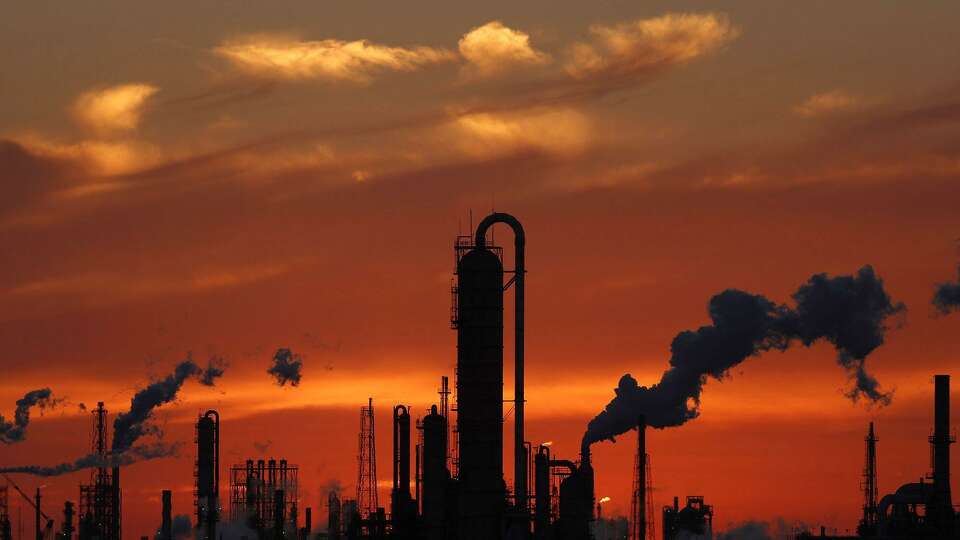 Emissions rise from an oil refinery at sunset in Texas City, Texas, on Feb. 16, 2017. MUST CREDIT: Bloomberg photo by Luke Sharrett.