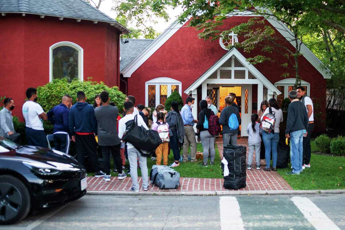 Immigrants gather with their belongings outside St. Andrews Episcopal Church last week on Martha's Vineyard. These are asylum seekers, not pawns in some misguided political game.