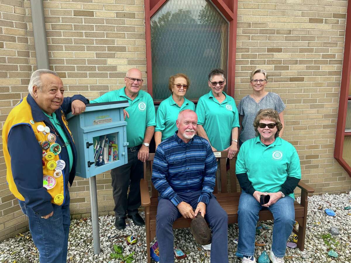 Members of the Mecosta County Optimists and Angels of Action organizations gathered to celebrate the installation of a new 'meditation bench' at the Angels of Action rock garden in Big Rapids. 