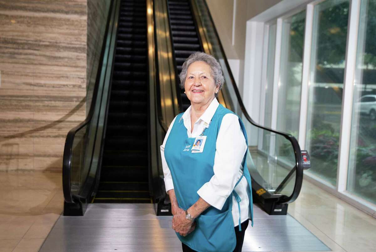 Memorial Hermann Memorial City Hospital volunteer greeter Nancy Kadala, 84, poses for a photograph Monday, Aug. 29, 2022, at hospital lobby in Houston. Kadala, 84, has been volunteering for nearly 30 years.