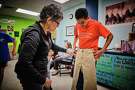 Jimenez helps Angel, a student at Spring Forest Middle School, check the sizing on a pair of pants.