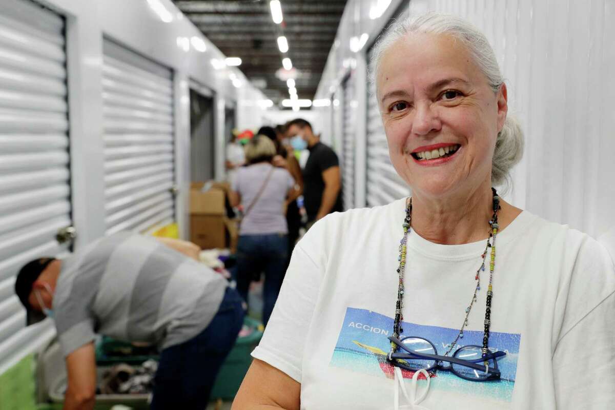 Diana Mendt, right, a community activist for Venezuelan immigrants, with those clients she oversees as they go through the free donations of clothes and household items at the Right Move Self Storage facility where the items are housed and distributed Saturday, Aug. 27, 2022 in Houston, TX.