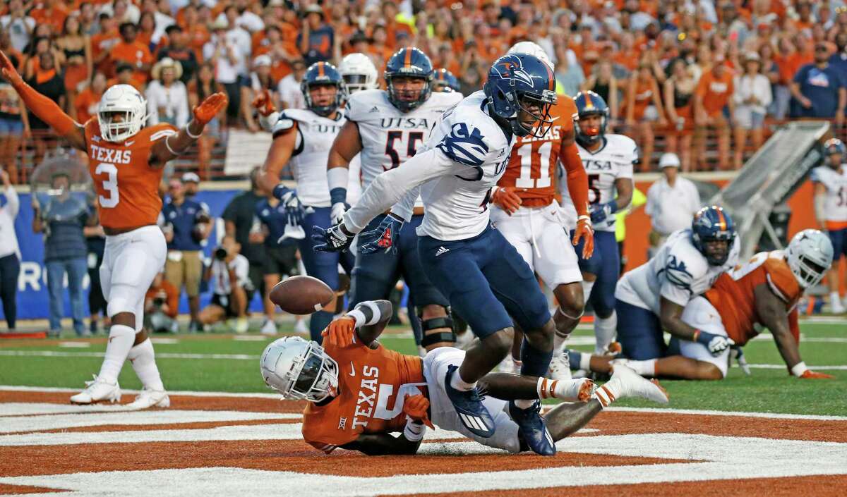 Texas cornerback D’Shawn Jamison breaks up a pass intended for UTSA receiver Zachary Franklin on Saturday in Austin.