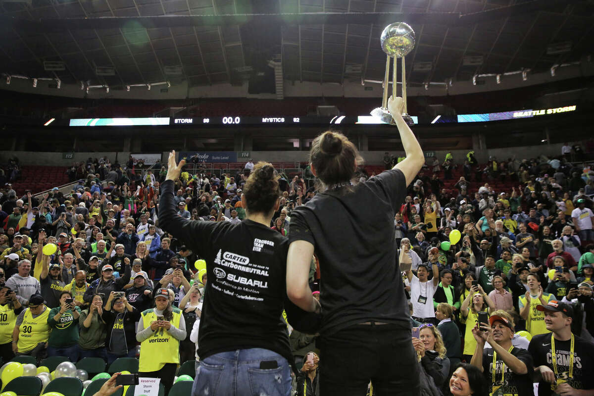 Seattle Storm guard Sue Bird and forward Breanna Stewart celebrate with the championship trophy during a rally at KeyArena to celebrate the Storm winning the 2018 WNBA basketball championship, Sunday, Sept. 16, 2018, in Seattle. (Genna Martin, seattlepi.com)