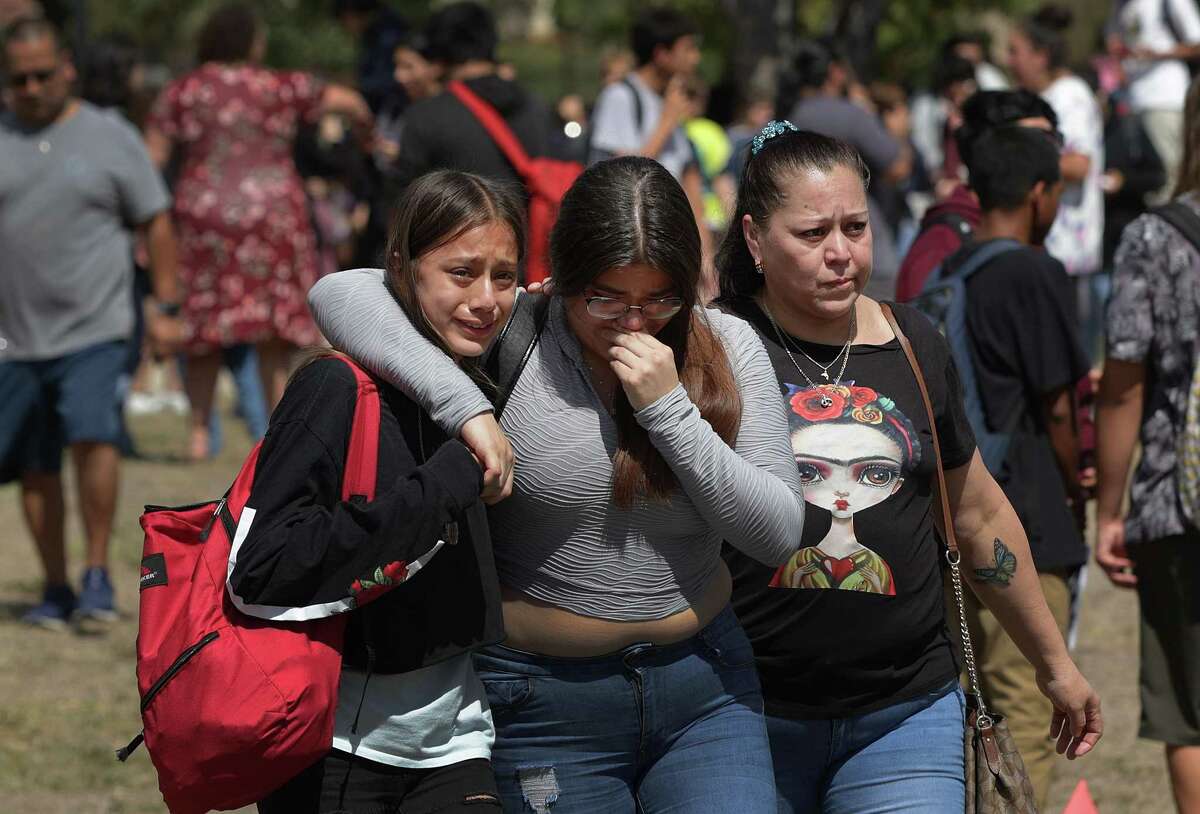 Students appear in tears as they exit Jefferson High School after a chaotic lockdown Tuesday. Parents swarmed the grounds and shouted at police, irate that their children couldn’t leave. It took more than an hour for officers to search the building and conclude that reports of gunfire had been a false alarm.