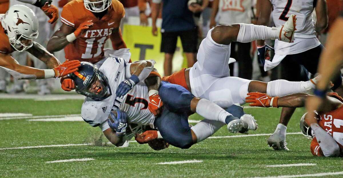 UTSA running back Brenden Brady is brought down after a gain on Saturday at Darrell K Royal Memorial Stadium in Austin