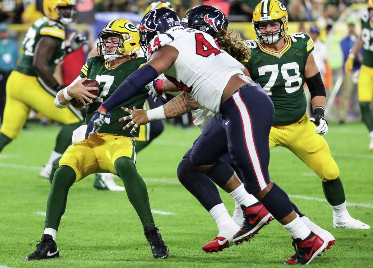 Houston Texans defensive end DeMarcus Walker (44) and defensive tackle Roy Lopez (79) sack Green Bay Packers quarterback Kurt Benkert (7) during the second half of an NFL pre-season football game Saturday, Aug. 14, 2021, in Green Bay, Wis.