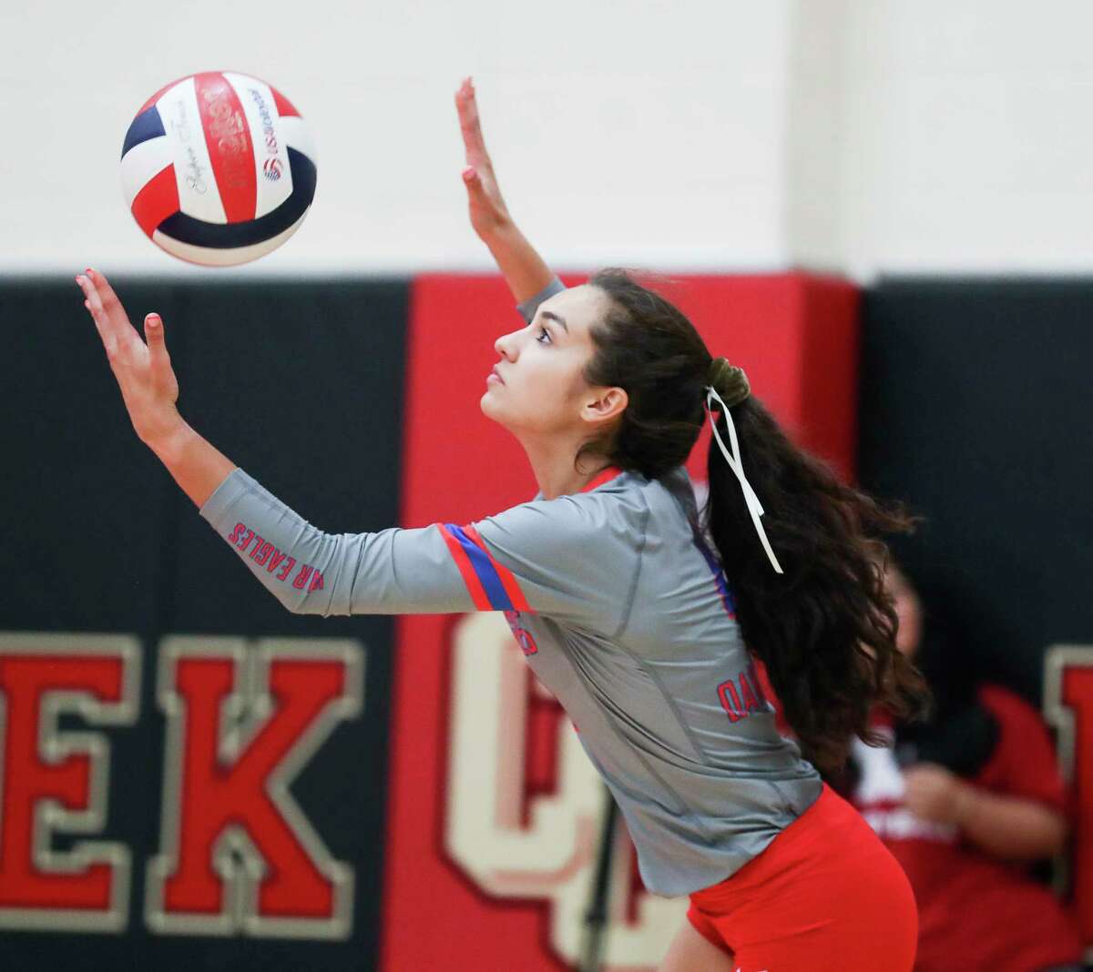 Oak Ridge's Lily Campos (4) serves the ball during the first set of a District 13-6A high school volleyball match at Caney Creek High School, Tuesday, Sept. 20, 2022, in Grangerland.