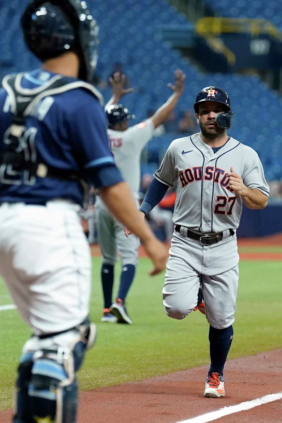 Houston Astros' Jose Altuve scores in front of Tampa Bay Rays catcher Francisco Mejia on an RBI double by Kyle Tucker during the first inning of a baseball game Tuesday, Sept. 20, 2022, in St. Petersburg, Fla. (AP Photo/Chris O'Meara)