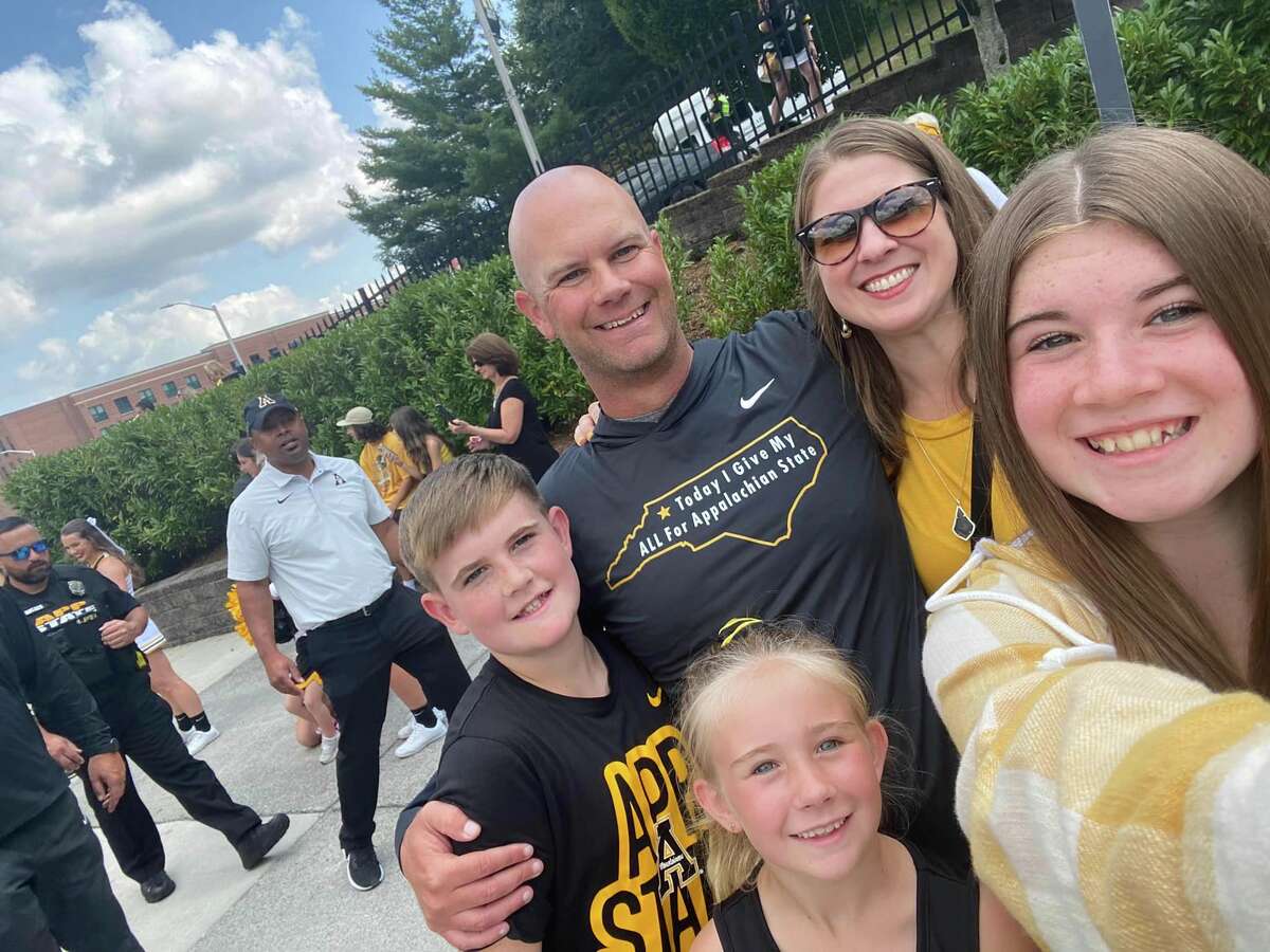 Kevin Barbay, along with wife Kacie and their children, Kynslie, Karoline and Karson, pose for a picture on the App State campus. 