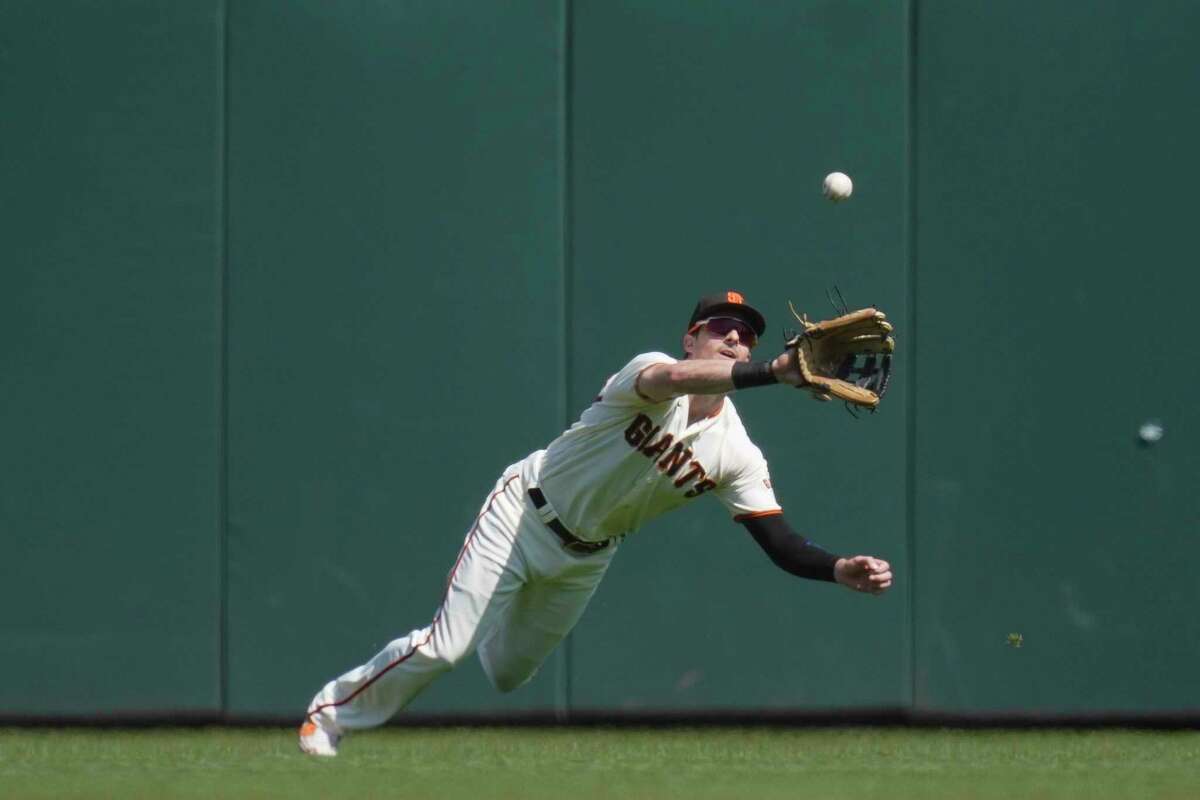 San Francisco Giants center fielder Mike Yastrzemski catches a fly out by Atlanta Braves' Vaughn Grissom during the fifth inning of a baseball game in San Francisco, Wednesday, Sept. 14, 2022. (AP Photo/Godofredo A. Vásquez)