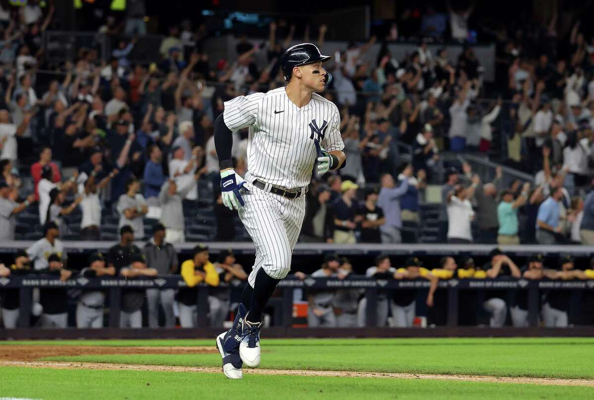 NEW YORK, NEW YORK - SEPTEMBER 20: Aaron Judge #99 of the New York Yankees hits his 60th home run of the season during the 9th inning of the game against the Pittsburgh Pirates at Yankee Stadium on September 20, 2022 in the Bronx borough of New York City. (Photo by Jamie Squire/Getty Images)