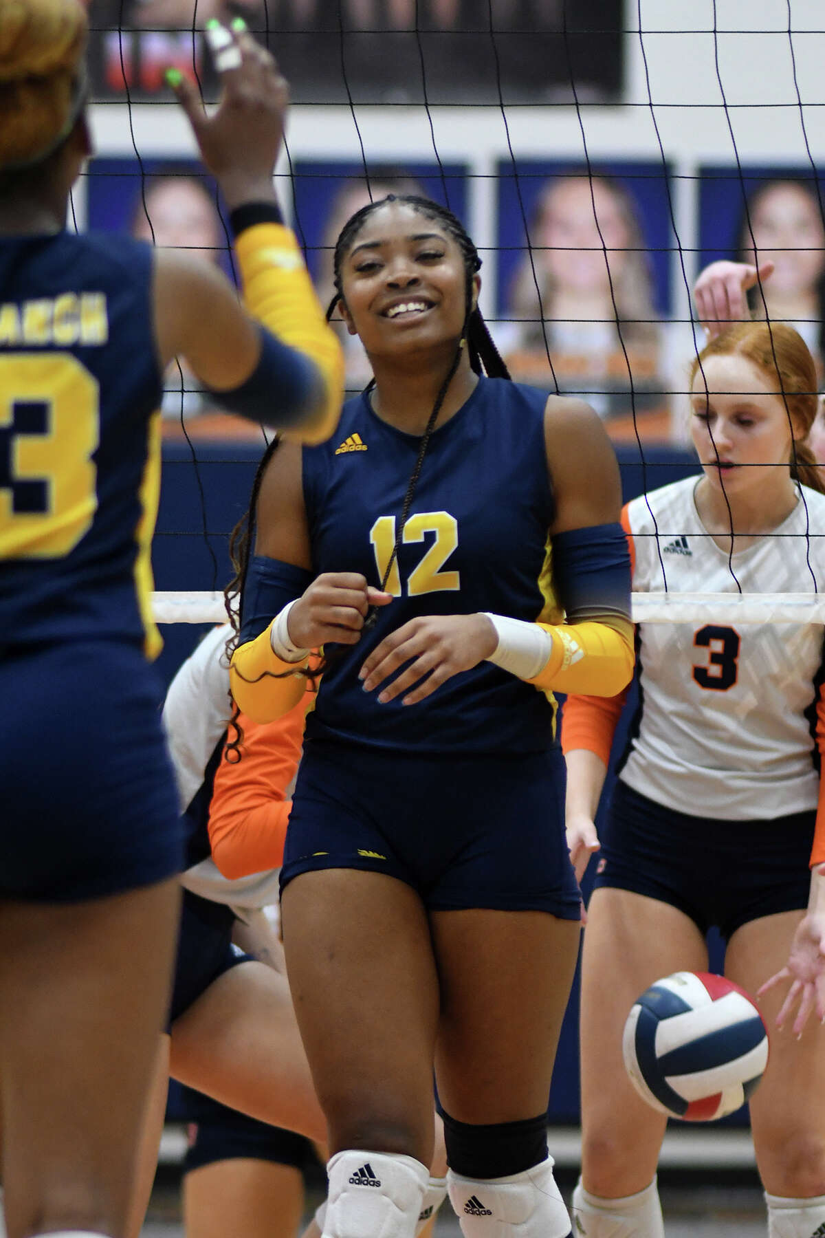 Cy Ranch senior middle blocker Janyah Henderson (12 celebrates a point with teammate Bianna Muoneke, left, against Bridgeland and senior setter Lauren McIntyre (3) during the second set of their district matchup at Bridgeland High School on Sept. 20, 2022.