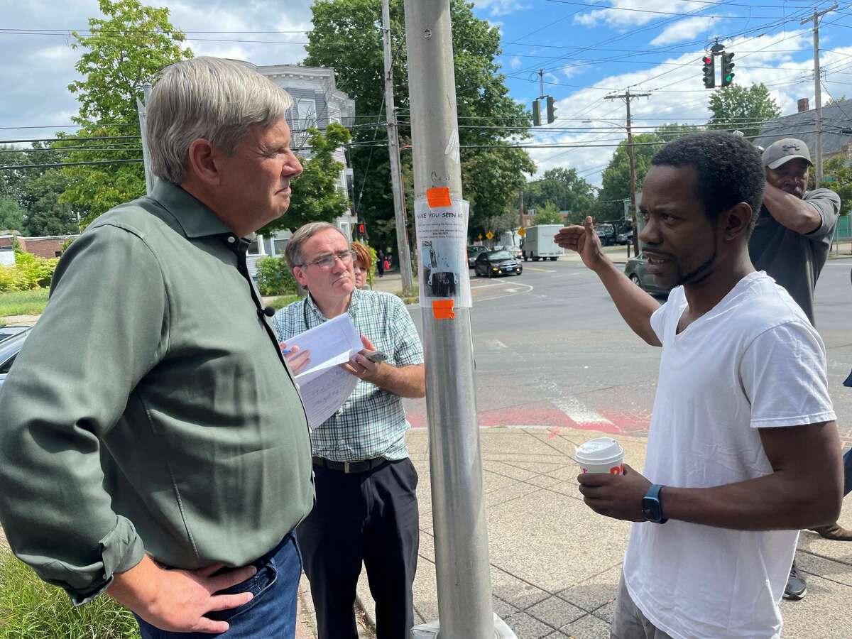 Bob Stefanowski speaks with New Haven resident Charles Murphy at the corner of Dixwell Avenue and Bassett Street in New Haven Tuesday. Murphy said politicians only come to his neighborhood every four years then disappear. 