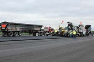 Heavy truck traffic near Albany airport as runway paving commences