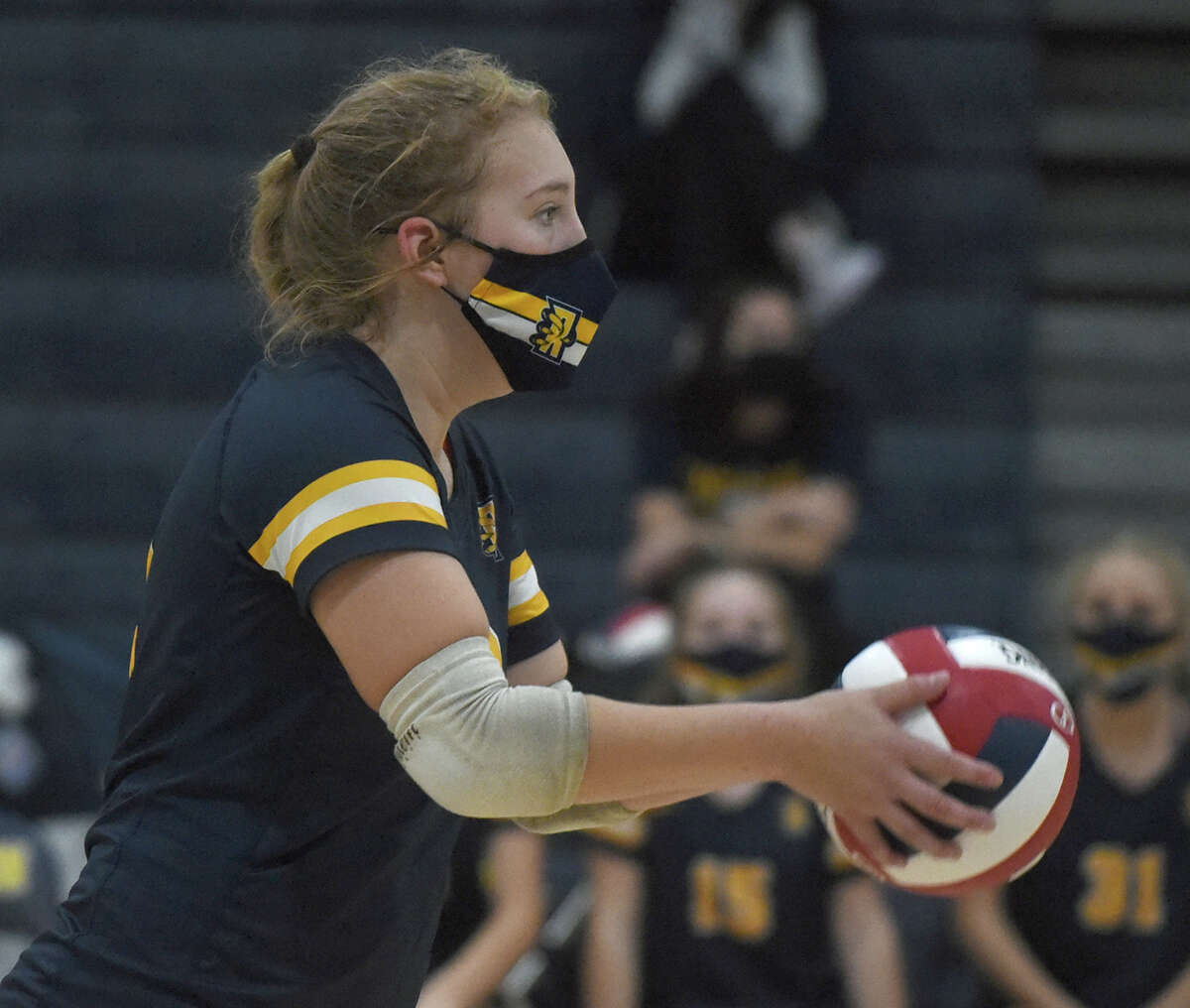 RHAM's Ally Hadley (18) gets set to serve against Simsbury during the 2021 CIAC Class L girls volleyball final in East Haven.