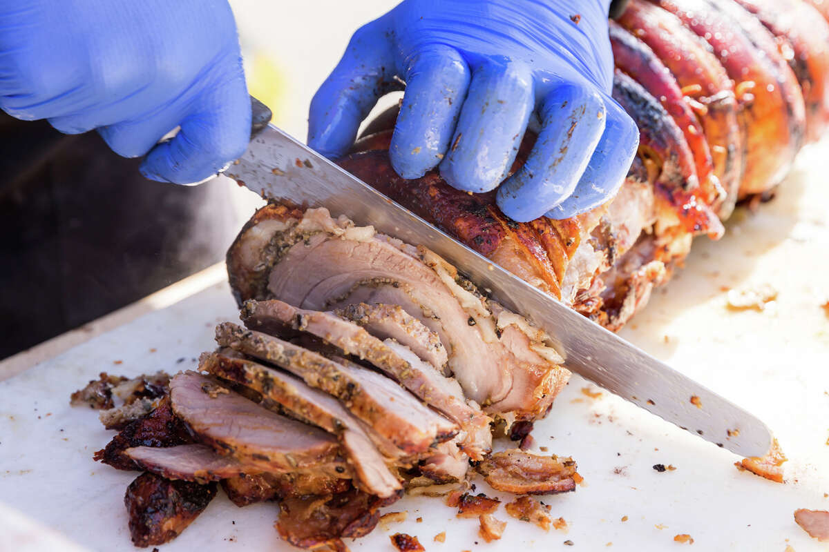Porchetta being sliced at the Roli Roti food truck at the Ferry Building in San Francisco, Calif. on Sept.
/p
p20, 2022.