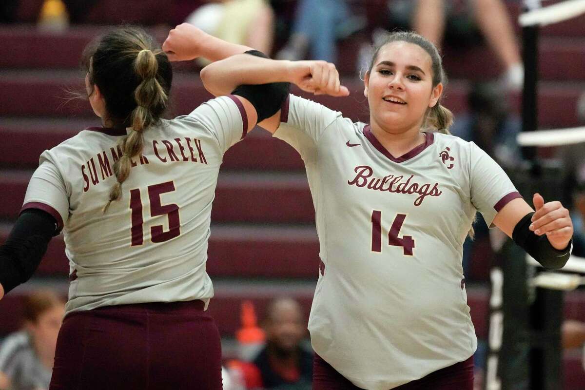 Summer Creek's Angelica Medina (14) and Anika Frausto lock arms before a high school volleyball match against Clear Brook, Tuesday, Aug. 30, 2022, in Houston.