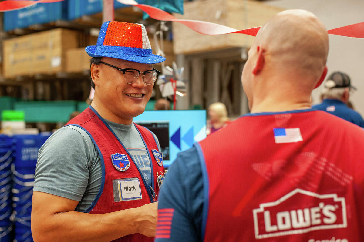 Midland resident Mark Xu Jian celebrates becoming a US citizen with his colleagues at Midland Lowes on September 21, 2022.  Gian has worked at Lowes for eight and a half years.